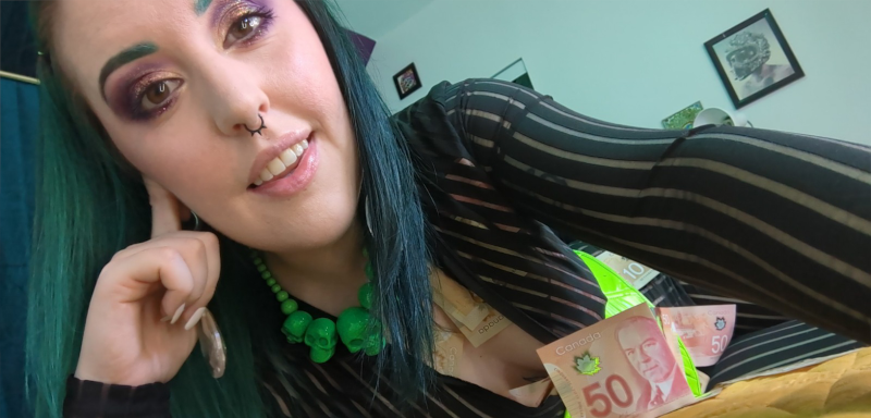 Greedy Femdom Findom Miss Faith Rae lays on her bed, covered in $50 and $100 bills. More cash is tucked into the unzipped cleavage of her catsuit, and into the top of her green corset. She will take everything you have, and you will love it.